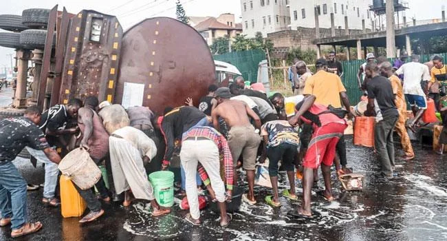 Residents scoop fuel as tanker falls in Lagos